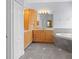 Bathroom boasting a soaking tub, tiled floors, and wooden cabinets at 32 Allenwood Look, Ormond Beach, FL 32174