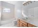 Bathroom with a shower-tub combo, white tile, and a wood vanity at 32 Allenwood Look, Ormond Beach, FL 32174