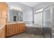 Well-lit bathroom showcasing double vanity, soaking tub, and glass enclosed shower at 32 Allenwood Look, Ormond Beach, FL 32174