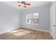This bedroom features a ceiling fan and tile floors with decorative trim at 32 Allenwood Look, Ormond Beach, FL 32174