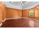 Large bedroom with tray ceiling, hardwood floors, and a window letting in lots of natural light at 32 Allenwood Look, Ormond Beach, FL 32174
