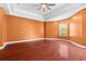 Spacious bedroom with tray ceilings, hardwood floors, and a sun-filled window at 32 Allenwood Look, Ormond Beach, FL 32174