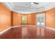 Bright bedroom features hardwood floors, tray ceiling, and french doors leading to the pool at 32 Allenwood Look, Ormond Beach, FL 32174