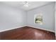 Cozy bedroom with hardwood floors, ceiling fan, and natural light from the window at 32 Allenwood Look, Ormond Beach, FL 32174