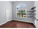 Bright bedroom with wood floors, a large window, and built in shelving at 32 Allenwood Look, Ormond Beach, FL 32174