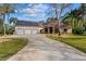 Well-maintained home featuring a three-car garage, solar panels, and landscaped front yard at 32 Allenwood Look, Ormond Beach, FL 32174