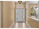 Home entry with tiled foyer, decorative light fixture, and transom window above the door at 32 Allenwood Look, Ormond Beach, FL 32174