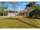 A beautiful home featuring a spacious manicured lawn, three-car garage, and solar panels at 32 Allenwood Look, Ormond Beach, FL 32174