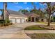 Beautiful house featuring a manicured lawn, three-car garage, and solar panels at 32 Allenwood Look, Ormond Beach, FL 32174