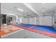 This garage has three garage doors, custom flooring, and storage cabinets at 32 Allenwood Look, Ormond Beach, FL 32174