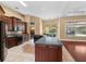 Spacious kitchen with dark cabinetry, tile floors, and views of the backyard at 32 Allenwood Look, Ormond Beach, FL 32174
