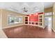 Bright living room features wood floors, coffered ceilings, and built-in shelving at 32 Allenwood Look, Ormond Beach, FL 32174