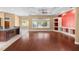Open-concept living room with wood floors and views of the pool at 32 Allenwood Look, Ormond Beach, FL 32174