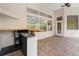 Poolside bar with sink, shelving, and electrical outlets on brick paver patio at 32 Allenwood Look, Ormond Beach, FL 32174