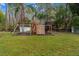 Backyard playground area features playset, swings, slide, climbing wall, and hammock at 32 Allenwood Look, Ormond Beach, FL 32174