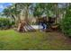 Backyard playground complete with playset, slide, climbing wall, and hammock at 32 Allenwood Look, Ormond Beach, FL 32174