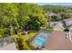 Aerial view showcasing a screened-in pool, backyard playground, and well-manicured landscaping at 32 Allenwood Look, Ormond Beach, FL 32174