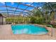 Inviting screened-in pool area with brick pavers, water feature, and lounge space at 32 Allenwood Look, Ormond Beach, FL 32174