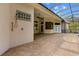 View of the poolside shower on the exterior of the home with a fan on the covered patio at 32 Allenwood Look, Ormond Beach, FL 32174