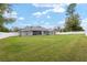 Spacious backyard with lush lawn and white fencing offering privacy and plenty of room for recreation at 5297 Se 39 Loop, Ocala, FL 34480