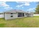 Expansive backyard with lush green grass and a screened-in porch at 5297 Se 39 Loop, Ocala, FL 34480