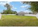 Landscaped backyard with manicured lawn and white fencing providing privacy and curb appeal at 5297 Se 39 Loop, Ocala, FL 34480