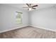 Bedroom with a ceiling fan and large window at 5297 Se 39 Loop, Ocala, FL 34480