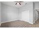 Cozy bedroom with neutral carpeting, ceiling fan, and a closet at 5297 Se 39 Loop, Ocala, FL 34480