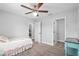 Bright bedroom with neutral carpet, light-colored walls, ceiling fan, and convenient access to the closet and rooms at 5297 Se 39 Loop, Ocala, FL 34480