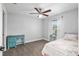 Bright bedroom with ceiling fan, light-colored walls and carpet, and a window for natural light at 5297 Se 39 Loop, Ocala, FL 34480