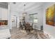 Well appointed dining room includes round table, stylish chairs, and modern lighting at 5297 Se 39 Loop, Ocala, FL 34480