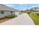 Long driveway leading to an attached two-car garage at 5297 Se 39 Loop, Ocala, FL 34480