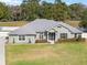 Charming single-story home featuring a well-manicured lawn, tasteful landscaping, and a welcoming entrance at 5297 Se 39 Loop, Ocala, FL 34480