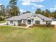 A nicely landscaped yard highlights this single Gathering home with mature trees, a lush lawn, and an inviting entrance at 5297 Se 39 Loop, Ocala, FL 34480