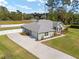 Well-maintained home featuring a long driveway, attached garage, and beautifully landscaped front yard at 5297 Se 39 Loop, Ocala, FL 34480