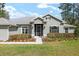 Charming home exterior featuring black trimmed windows, neutral paint, and well manicured landscaping at 5297 Se 39 Loop, Ocala, FL 34480