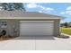 Attached two-car garage featuring a smooth white garage door and neutral paint at 5297 Se 39 Loop, Ocala, FL 34480