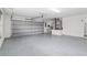 Spacious two-car garage with epoxy flooring, modern lighting, and an insulated garage door at 5297 Se 39 Loop, Ocala, FL 34480