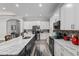 Modern kitchen featuring a large island, white cabinets, stainless steel appliances, and hardwood floors at 5297 Se 39 Loop, Ocala, FL 34480
