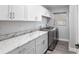 Bright laundry room featuring white cabinets and modern washer and dryer at 5297 Se 39 Loop, Ocala, FL 34480