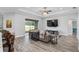 Open-concept living area with a comfortable sectional sofa, large windows, and seamless access to outdoor space at 5297 Se 39 Loop, Ocala, FL 34480