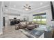 Spacious living room with a sectional sofa, hardwood floors, and an open layout connecting to the kitchen at 5297 Se 39 Loop, Ocala, FL 34480