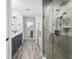 Bright main bathroom featuring double sinks with marble countertops and a glass shower enclosure at 5297 Se 39 Loop, Ocala, FL 34480