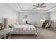Spacious main bedroom featuring a tray ceiling, carpet, and ensuite bathroom at 5297 Se 39 Loop, Ocala, FL 34480