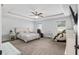 Spacious main bedroom featuring a tray ceiling, carpet, and ensuite bathroom at 5297 Se 39 Loop, Ocala, FL 34480