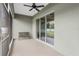 Relaxing screened patio features ceiling fan and sliding glass doors to the backyard at 5297 Se 39 Loop, Ocala, FL 34480