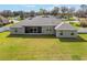 Beautiful home showcasing a well-maintained lawn, screened-in porch, and grey exterior paint at 5297 Se 39 Loop, Ocala, FL 34480