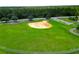 Aerial shot of the ball field; a great place for neighborhood children to play and exercise at 55 Sw Fig Tree Ln, Dunnellon, FL 34431