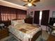 Inviting bedroom with a comfortable queen-sized bed, bedside tables, and natural light at 55 Sw Fig Tree Ln, Dunnellon, FL 34431