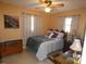 Comfortable bedroom featuring a bed, side tables, and natural light at 55 Sw Fig Tree Ln, Dunnellon, FL 34431